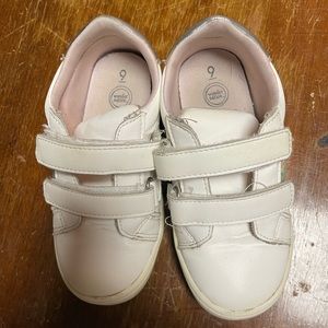 White Size Nine tennis shoes with rainbow embellishment.